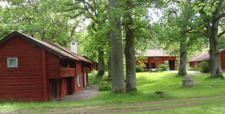 Björnlunda hembygdsgård med vandrarhemmet och stora ekar.