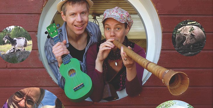 Victoria och en man sticker fram huvudet ur ett hål i ett plank, spelandes på ett varsitt instrument.